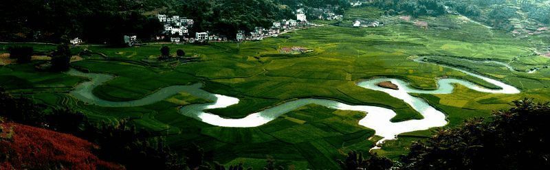 游戏内巴马地图场景，碧绿河水环绕着群山