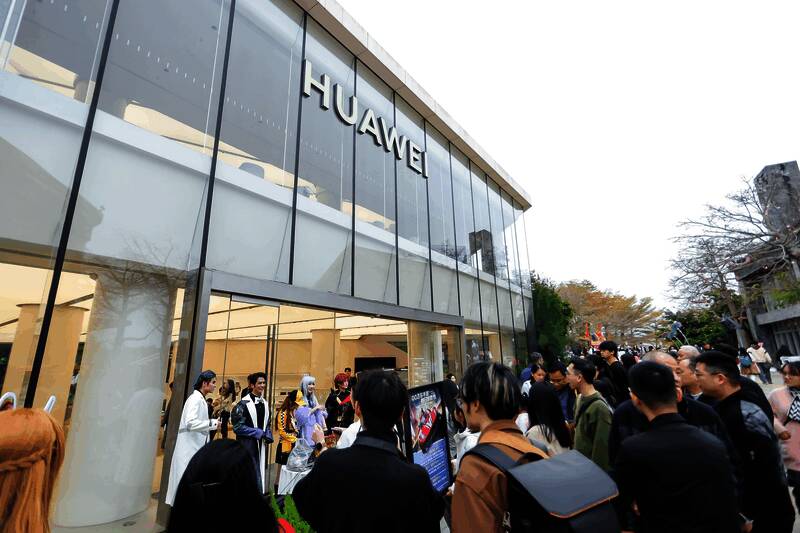 玩家在华为门店体验《QQ飞车》，气氛热烈，多人围观参与