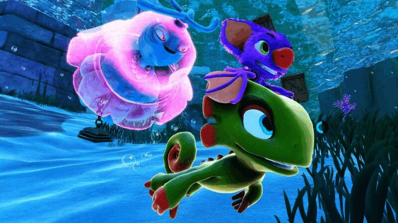 Playtonic Games工作室团队合影，背景为公司标志与电脑屏幕