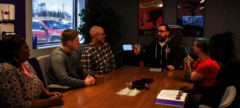 AbleGamers活动或会议现场图片，显示创始人与其他参与者互动