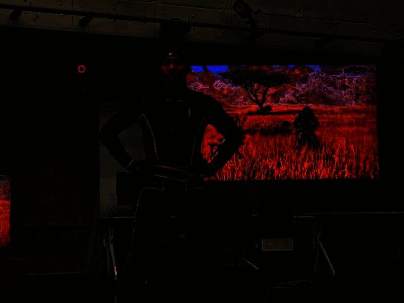 一名演员正在模拟大型四足怪物的行走姿态，动作极具力量感