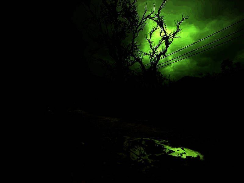 《潜行者2》游戏中一片荒废的废弃城市景象，远处雷云密布，建筑残骸遍布，光影对比强烈