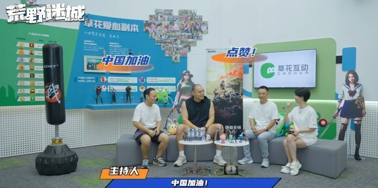 张志磊面对镜头，双手比心为中国队加油，背景是奥运五环图案