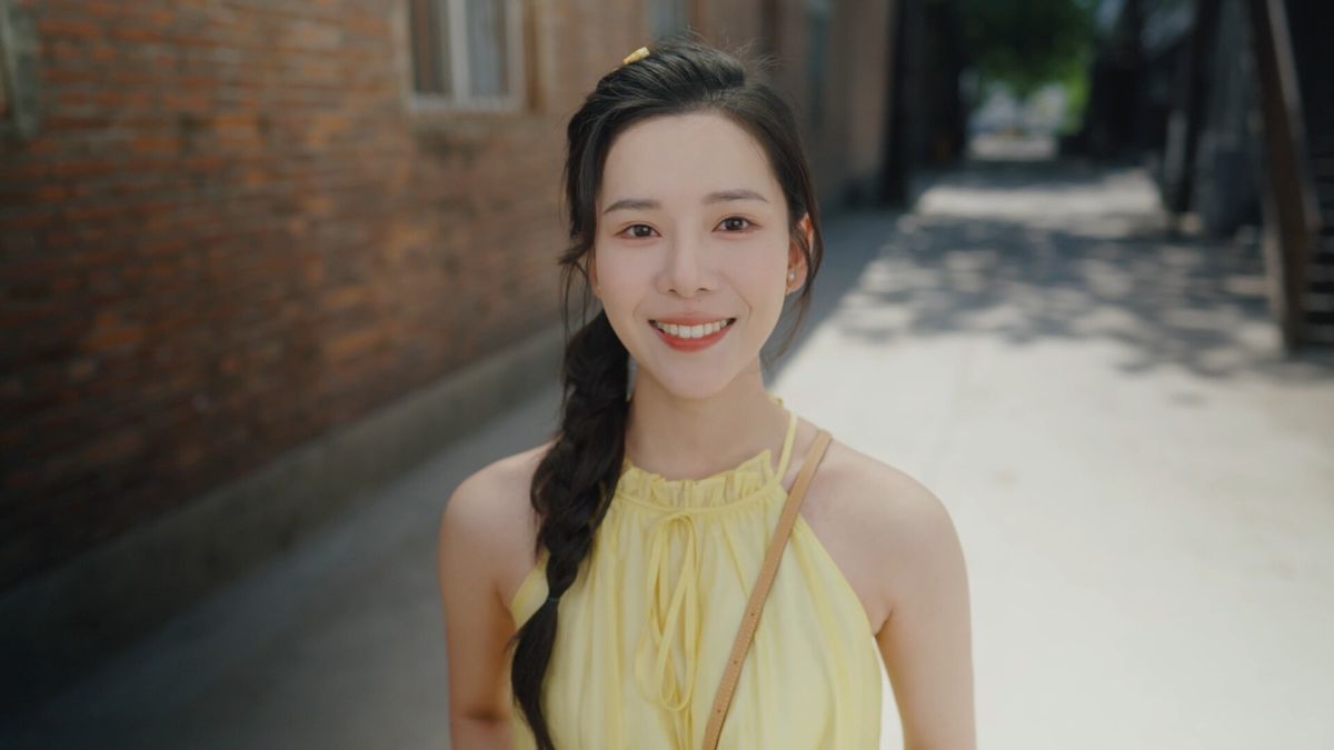 女主角在灯光下微笑的特写镜头，眼神温柔，极具感染力