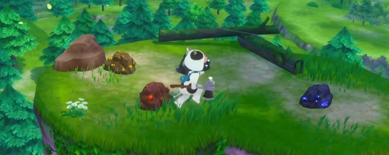 《牧场物语 来吧！风之繁华集市》中矿洞内部场景，玩家角色手持镐子正在敲击矿壁，周围散落着不同种类的矿石