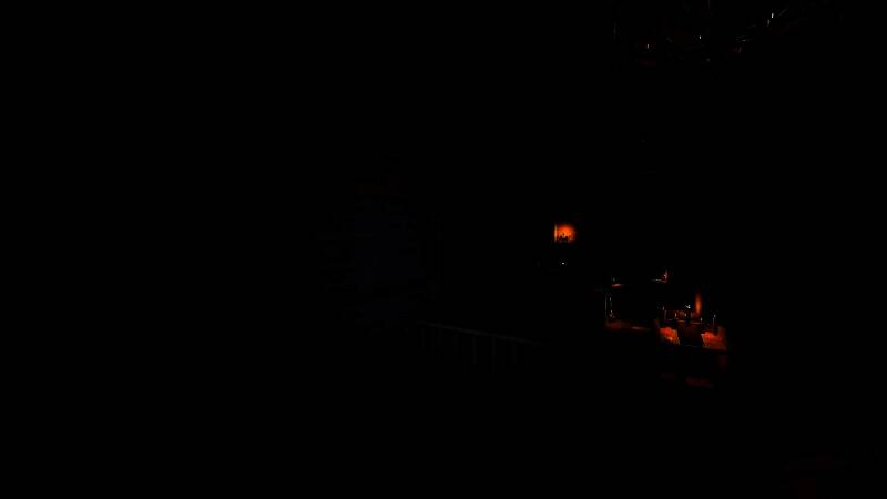 预告片截图：一名玩家手持EMF探测器在阴森老宅中缓慢前行，光线微弱，气氛紧张