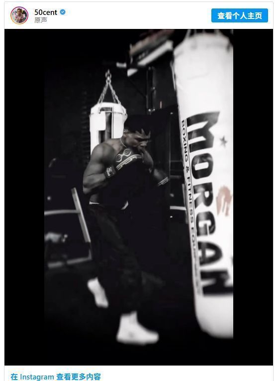 50美分站在擂台中央摆出拳王标志性姿势，双拳紧握，目光如炬